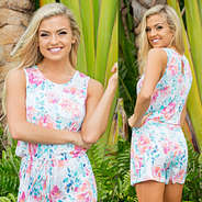 girl wearing a Monogrammed Romper in front of palm trees
