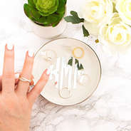 silver monogrammed ring dish with girl trying on ring