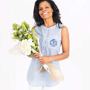 model holding flowers wearing monogrammed seersucker top