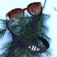 monogrammed black sunglass strap on brown sunglasses