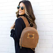 brunette wearing mini sherpa backpack