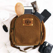 Mini Sherpa Backpack with items spilling out
