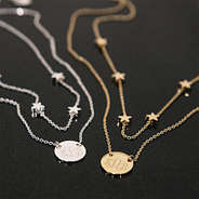 duo star necklace on black background