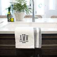 monogrammed dish towel set in black hanging off of kitchen sink