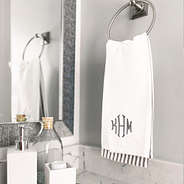 Gray hand towel set hanging in powder room