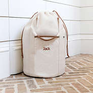 Ivory Monogrammed Packable Laundry Bag on tiles