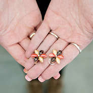 brown flower earrings held in hand