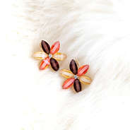 flower stud earrings on white carpet
