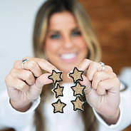 star earrings in hands