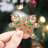 gingerbread earrings with tree behind them