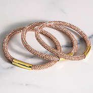 close up of rose gold bangle set