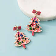 beaded christmas earrings in pink on blue background