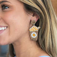 girl wearing pumpkin spice earrings
