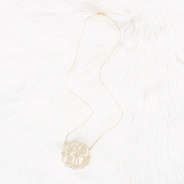 gold monogrammed lacey necklace on faux fur