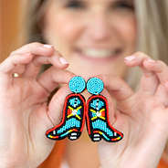 cowboy boot earrings in hands