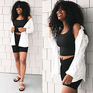 black crossover biker shorts with black tank top and white button down tunic