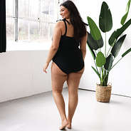 back of black monogrammed one piece bathing suit showing coverage