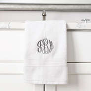 white hand towel hanging off the sink