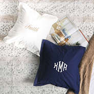 white and navy monogrammed pillow shams on blanket