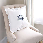 white scalloped pillow sham on chair