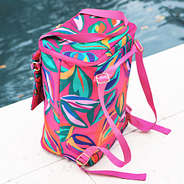 back of pink island sunset backpack cooler near pool