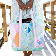 girl holding blue safari mesh beach bag set on boardwalk