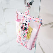 coral floral shower bag hanging in shower