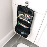 black packable travel case hanging in bathroom