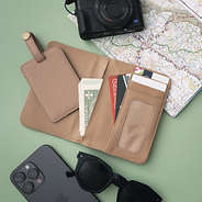 inside of monogrammed passport carrier case and luggage tag in taupe