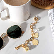 Monogrammed Link Charm Bracelet on table with sunglasses, book and coffee