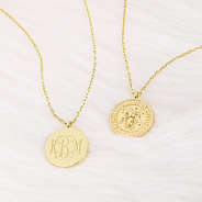 bee pendant necklace on fur rug