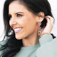 girl wearing bride earrings with puffy sleeve sweatshirt