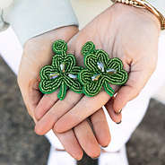 shamrock earrings in hands