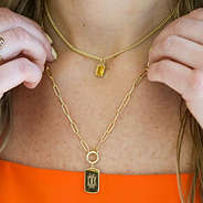 monogrammed tag necklace on girls neck