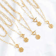 assorted initial layered necklaces on shet