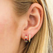 rainbow huggie hoop earrings in ear
