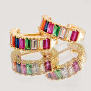 rainbow huggie hoop earrings on mirror