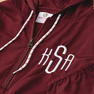 close up of crimson monogrammed pullover rain jacket