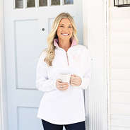 girl wearing quarter zip sweatshirt in pink seersucker