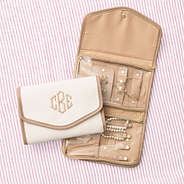 ivory travel jewelry organizer on pink striped background