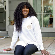 white crewneck sweatshirt on girl sitting on cabin porch new