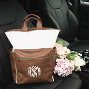 ivory commuter backpack in car with flowers