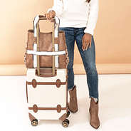 neutral aztec purse tote on suitcase