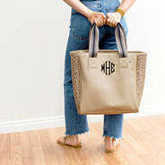 gold leopard tote purse held behind the back