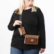 meredith wearing monogrammed camel dottie crossbody purse