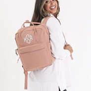 personalized canvas backpack in blush over shoulders