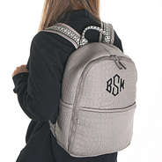 textured monogrammed grey neoprene backpack on back