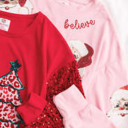 close up of pink and red christmas sweatshirts