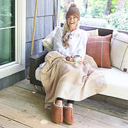 girl snuggled in checkered blanket