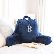 navy lounge pillow cover on bed with book